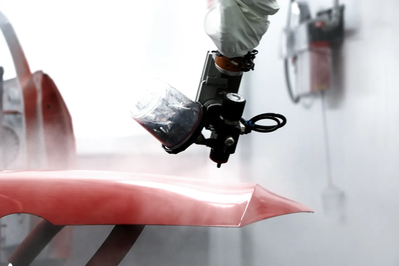 SATA Automation "jetstream" painting robot coating a car bonnet